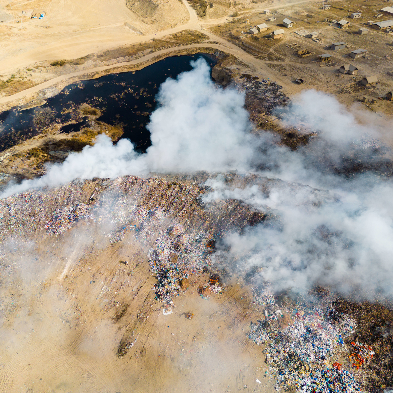 Aerial view of landfill burning trash piles
