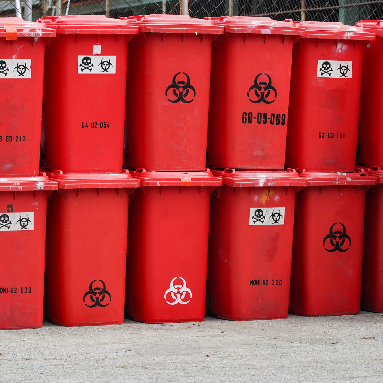 Stack of red biohazardous waste bins