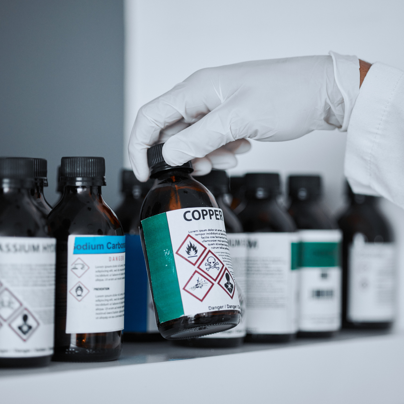 Scientist perusing chemical shelf