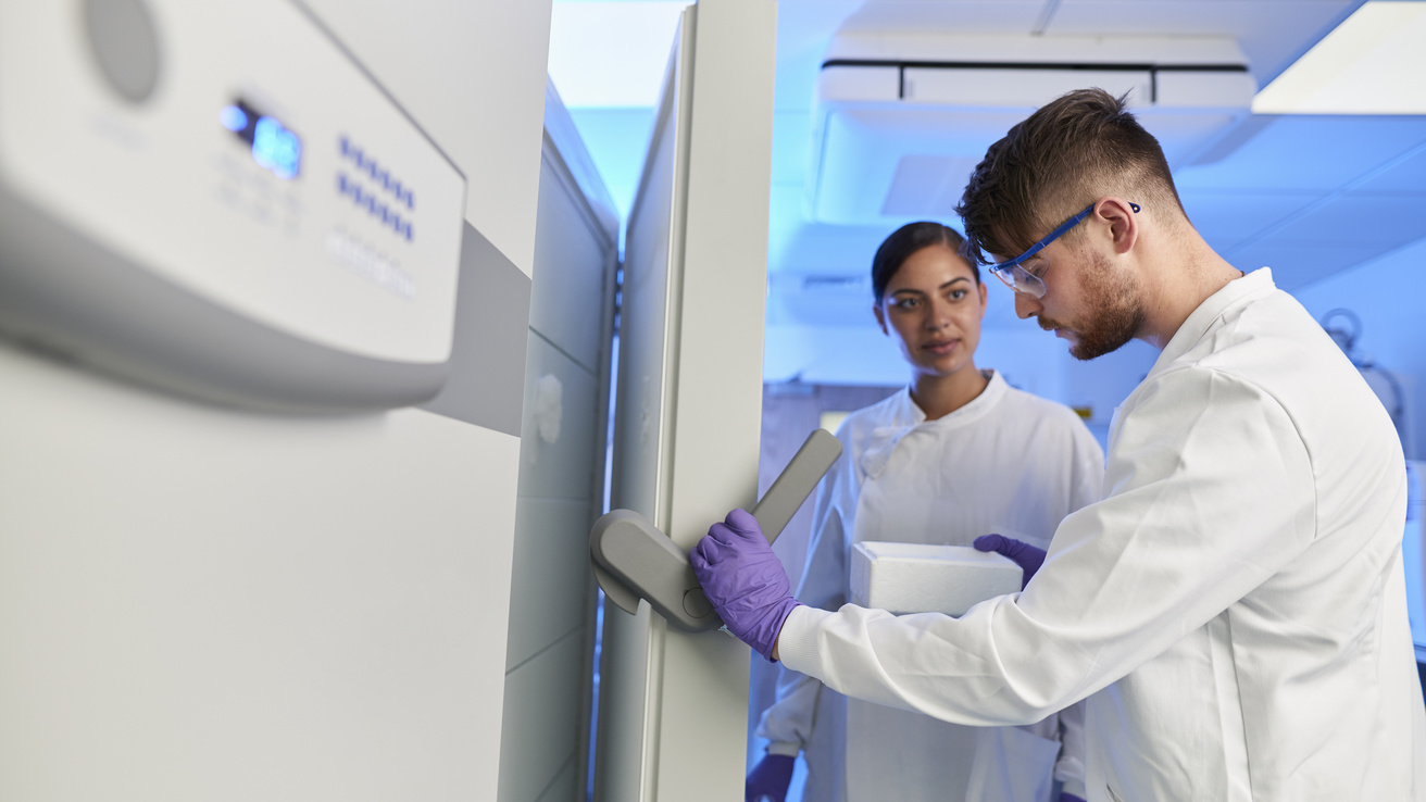 Scientists retrieving samples from cold storage